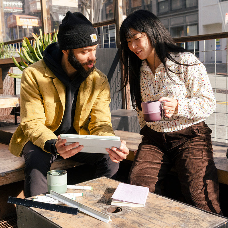 12oz-rise-mug-w4 12oz_rise_coffee_mug_dusty_orchid_couple_city_patio_square.jpg
