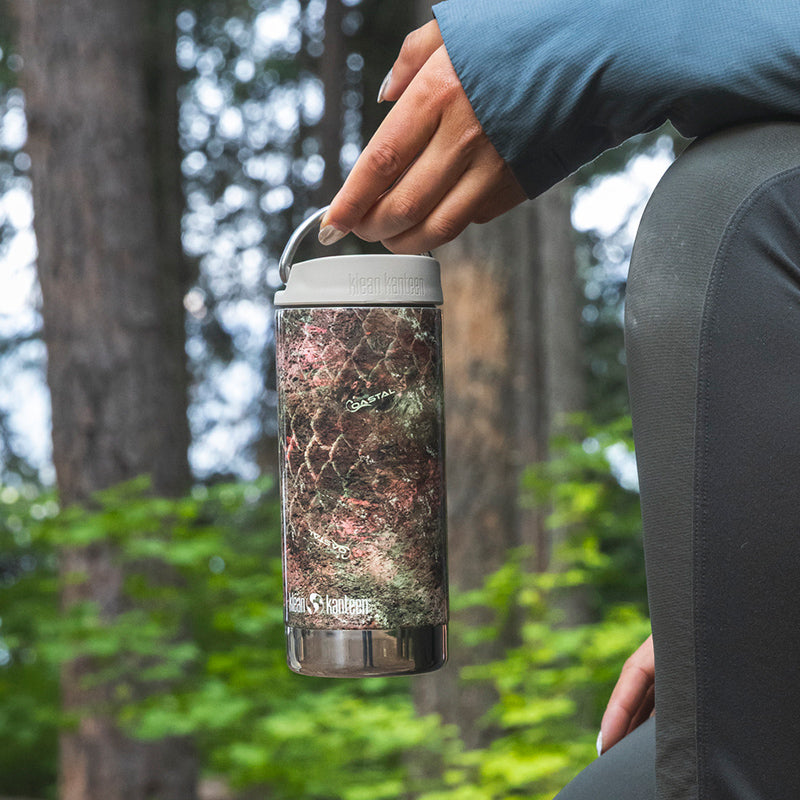 12oz-tkwide-with-cafe-cap-mossy-oak-z5 12oz_tumbler_mossyoak_rainbowtrout_hand_closeup_square.jpg
