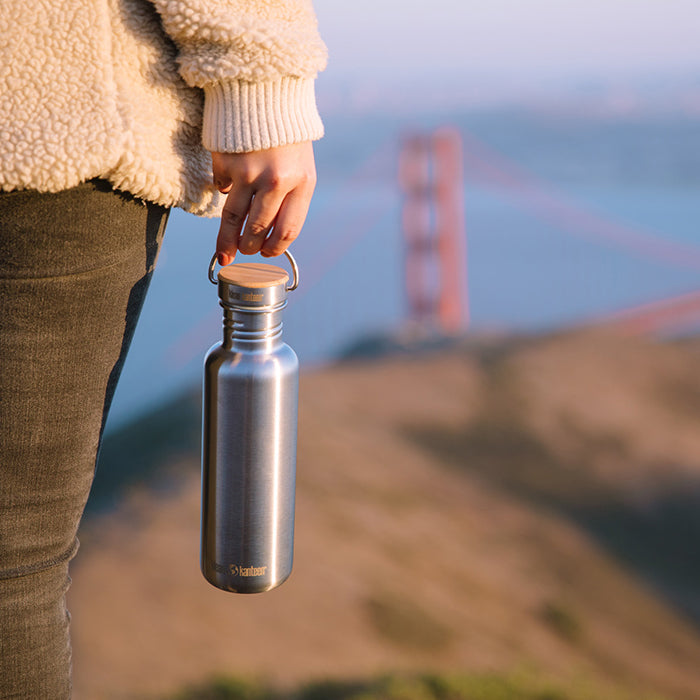 27oz-reflect-with-bamboo-cap-c5 K27SSLRF-BS-BAMBOO_reflect_bottle_bridge_lifestyle.jpg